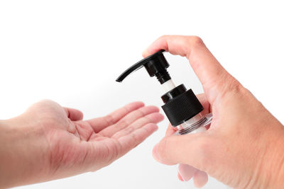 Cropped image of man holding hands over white background