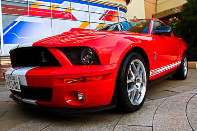 Red vintage car on street in city