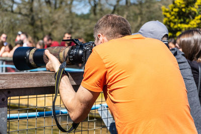 Rear view of man photographing