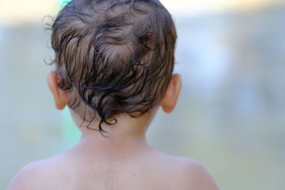 Baby / toddler back of head wet hair playing at splash pad