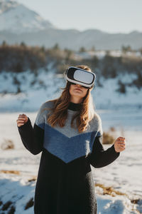 Portrait of young woman standing at beach