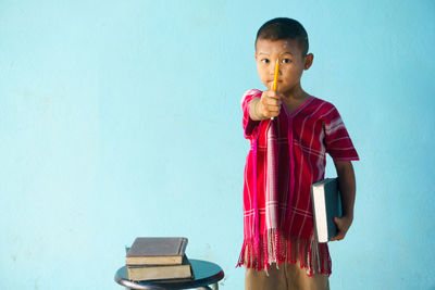 Boy against blue background