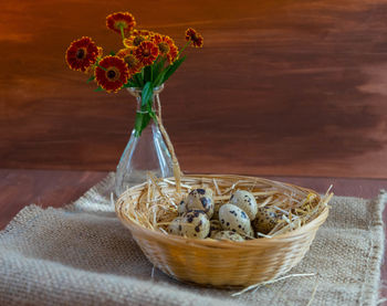 Close-up of red glass in basket on table