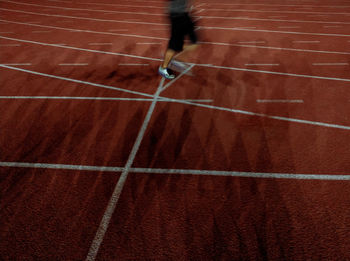 Low section of person running on brick wall