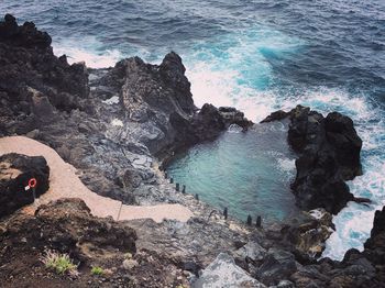 High angle view of rocks on sea shore