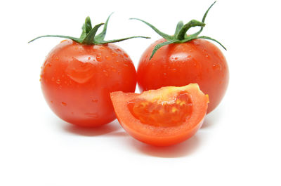 Close-up of tomatoes against white background