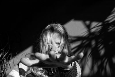 Portrait of woman with outstretched arm 