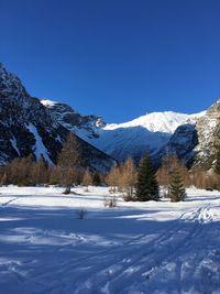 Scenic view of snowcapped mountains against blue sky