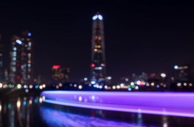 Defocused image of illuminated city at night