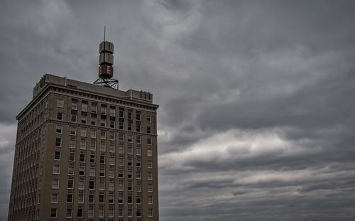 Low angle view of building against cloudy sky