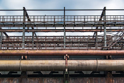 Low angle view of factory against sky