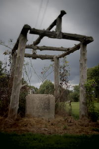 Abandoned built structure on field against sky