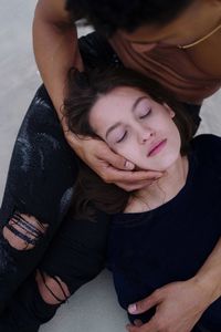 High angle view of young woman lying in her boyfriend arms