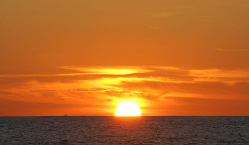 Scenic view of sea against orange sky