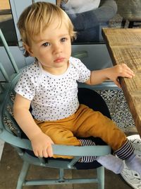 Cute boy sitting on chair