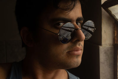 Close-up portrait of young man wearing sunglasses