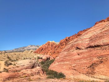 Scenic view of mountains against clear blue sky