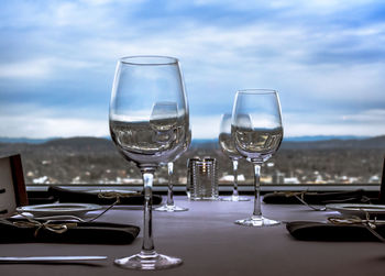 Wineglasses on table against window