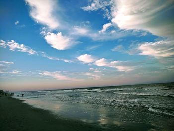 Scenic view of beach against sky during sunset