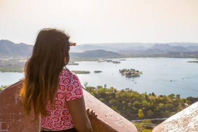 Rear view of woman looking at lake