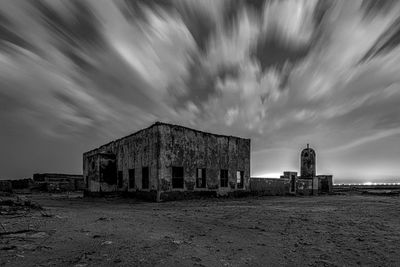 Old building on field against sky