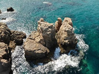 High angle view of rocks on sea shore