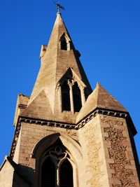 Low angle view of building against clear blue sky