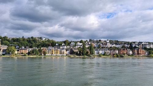 View of townscape by sea against sky