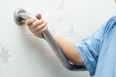 Midsection of man working on wall