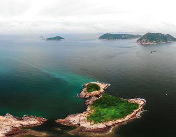 High angle view of rocks on sea shore against sky