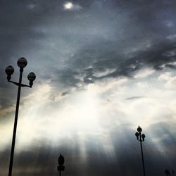 Low angle view of street light against cloudy sky