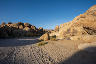 Rock formations in desert against blue sky