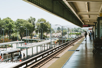 People walking on railroad station platform