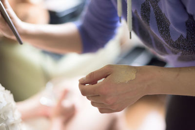 Close-up of make-up artist hand with foundation base