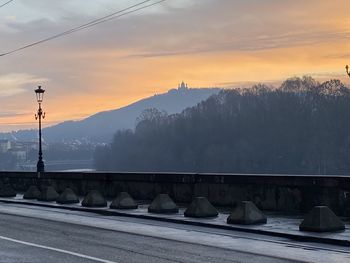 Snow covered mountains against sky during sunset