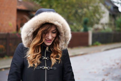 Close-up of smiling young woman wearing warm clothing