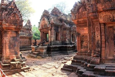 Damaged temple in forest against sky