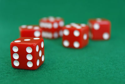 Close-up of red dice on green table