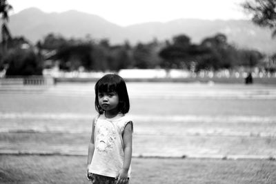 Portrait of boy standing on field