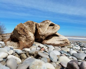 Rocks by sea against sky