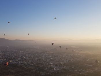 Hot air balloons flying in city