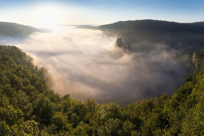 Scenic view of trees and mountains against sky