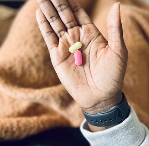 Woman holding pills in right hand