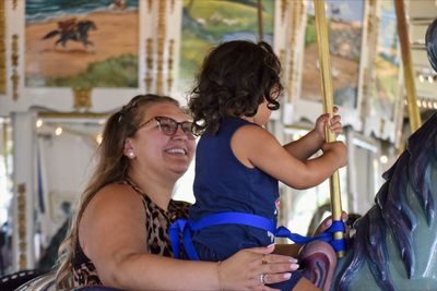 Portrait of a smiling young woman sitting outdoors