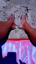 Low section of person legs on sand