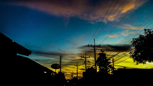 Low angle view of electricity pylon against sky