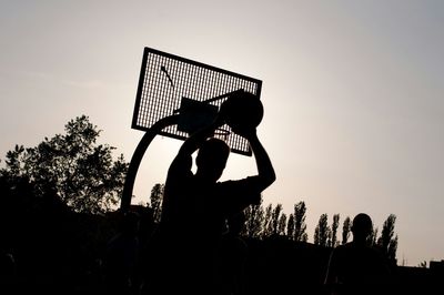 Low angle view of people against sky