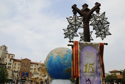 Low angle view of text on building against sky
