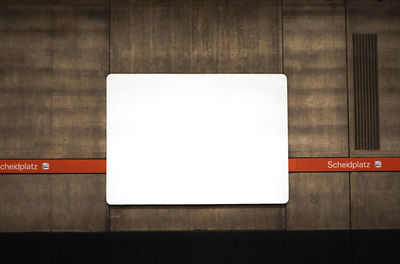 Close-up of arrow sign on wall
