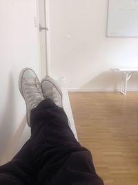 Low section of woman standing on tiled floor